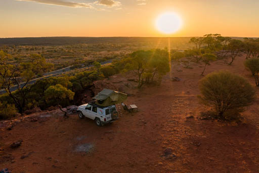 roof tent camping on a 4wd at dusk in the Outback