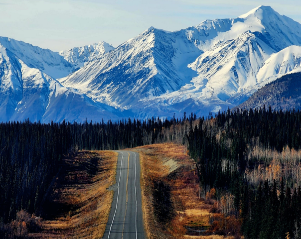 The Alaska Highway with Mountains in background
