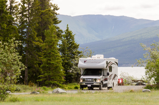 Camper parked next to lake in Whitehorse