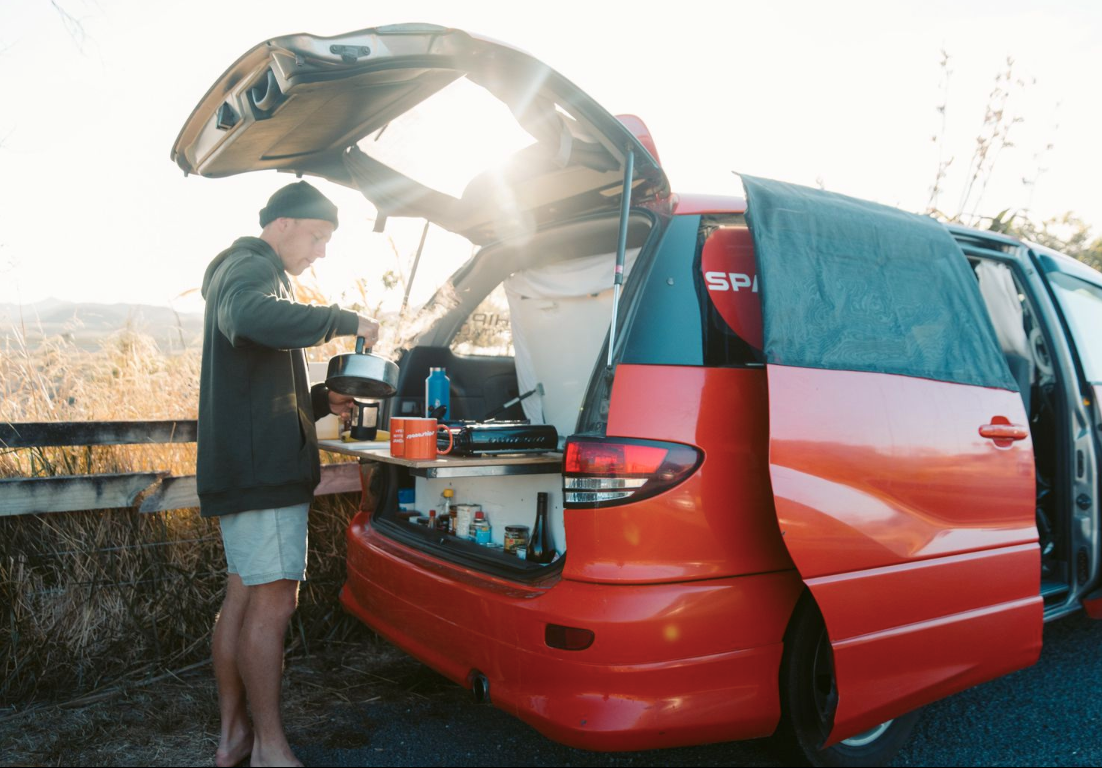 man making a cup of tea on campervan rental australia