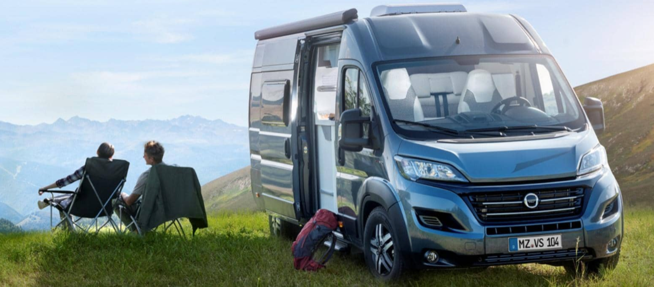 Two men outside campervan vehicle