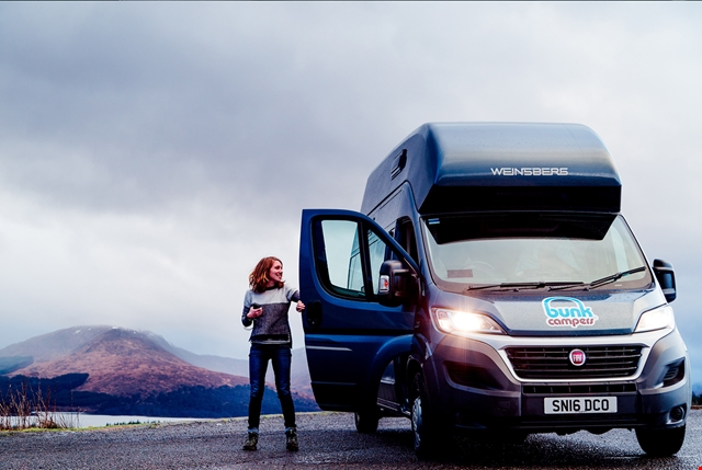 woman closing door of motorhome vehicle