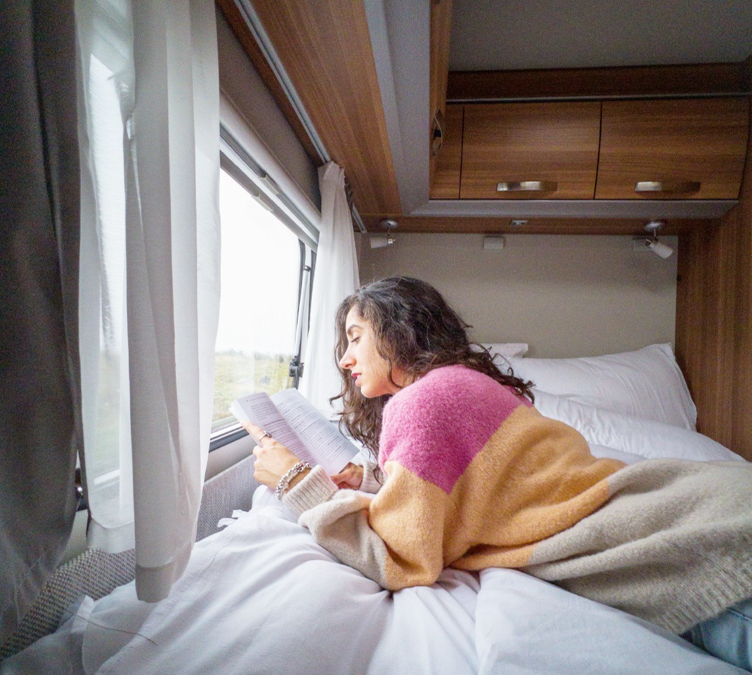 woman reading in her bunk campers motorhome hire
